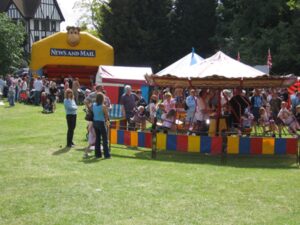 Esher News and Mail bouncy castle and traditional fairground swings